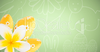 Yellow flower and eggs against green easter pattern