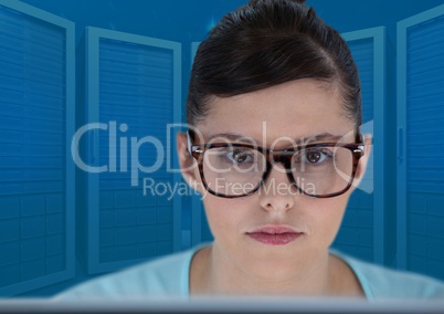 Woman on laptop with blue servers background