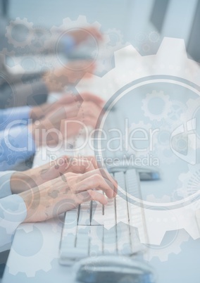 Hands at computers with gear graphic overlay