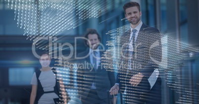 Three business people with blue map graphic overlay