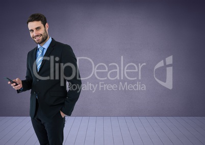 Businessman with phone against purple background