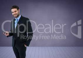 Businessman with phone against purple background