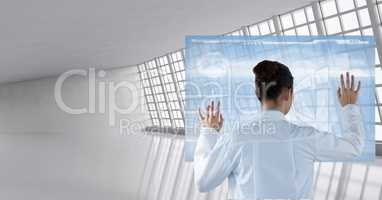 Doctor ( woman) using futuristic tactile screen at the hospital