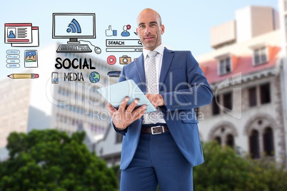 Digital composite image of businessman using tablet PC by icons representing social media