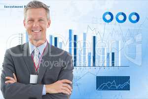 Happy businessman standing arms crossed against graphs