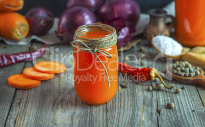 Juice from fresh vegetables in a glass jar on a table