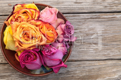 Rose petals in a bowl in the colors of a sunset