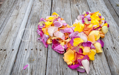 Rose petals in the shape of a heart in the colors of a sunset