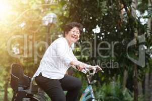 Elderly Asian woman biking