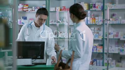 Girl giving prescription to pharmacist in pharmacy