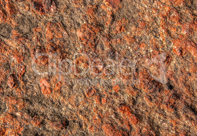 Background of red granite with a rough surface