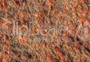Background of red granite with a rough surface
