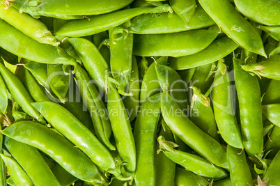 Background of young green peas in the pod