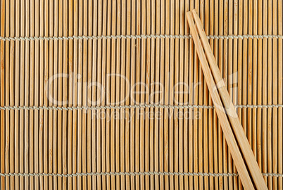 Bamboo sushi mat and chopsticks on top