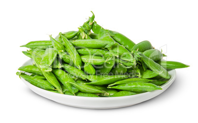 Big pile of green peas in pods on white plate