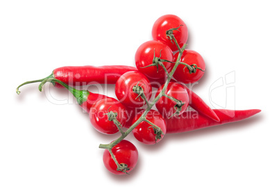 Branch of cherry tomatoes and two red chili peppers