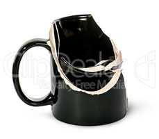 Broken black ceramic cup fragments are inside