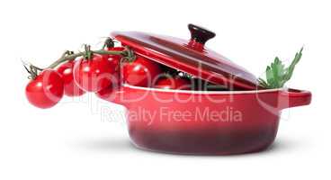 Cherry tomatoes and parsley in saucepan with lid