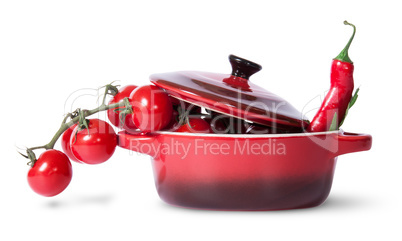 Cherry tomatoes with parsley and chili in saucepan
