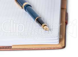 Closeup fountain pen on top of the open notebook