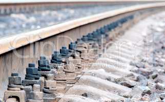 Closeup of rails and sleepers leaving afar