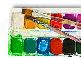Closeup of watercolor paints set and brushes