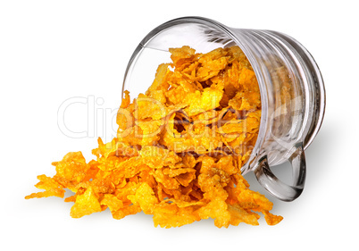 Cornflakes spill out of a glass cup