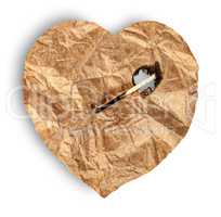 Crumpled paper heart burns match