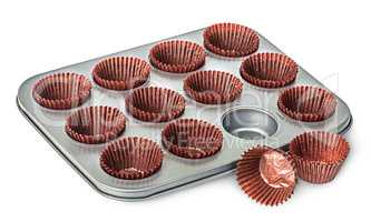 Cupcake and muffin pan with paper cups some beside