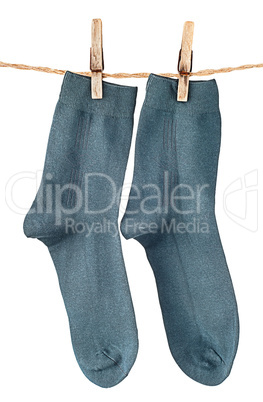 Dark blue socks on rope with clothespins