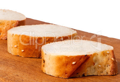 Delicious fresh bread sliced on a wooden board