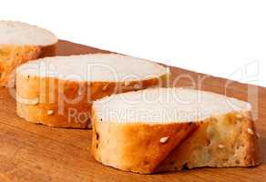 Delicious fresh bread sliced on a wooden board