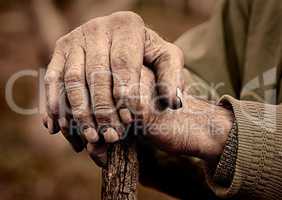 Elderly man hand holding a staff