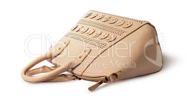 Elegant leather beige handbag lying
