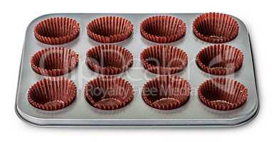 In front cupcake and muffin pan with paper cups