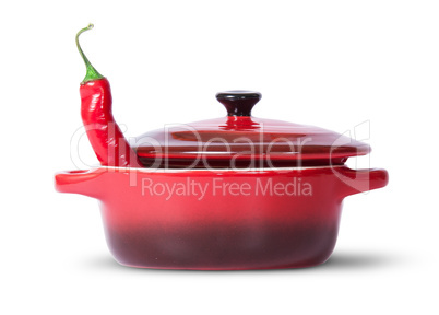 In front red chili pepper in saucepan with lid