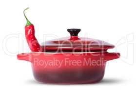 In front red chili pepper in saucepan with lid