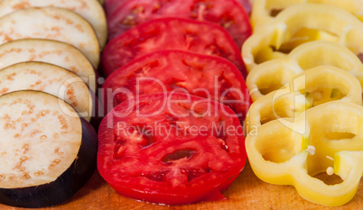 In front sliced eggplant tomato and sweet pepper