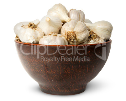 In front whole head of garlic in ceramic bowl