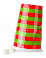 Inverted red and green cup with sugar cubes