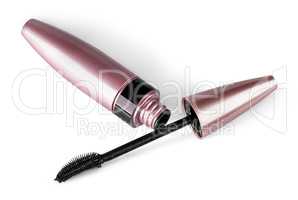 Mascara and brush lying beside