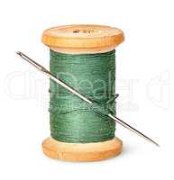 Needle and thread on wooden spool vertically