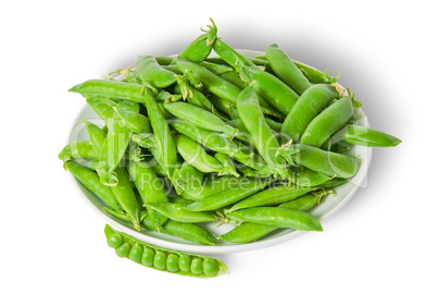 Opening and closing pea pods on white plate top view