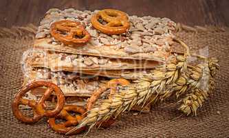 Pile cereal cookies with seeds and wheat ears on sacking