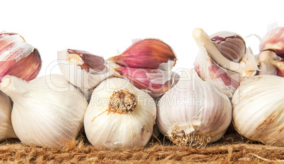 Pile of whole and cloves of garlic on sackcloth