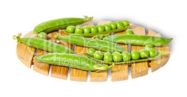 Pods of peas on bamboo small board