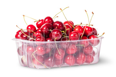 Red juicy sweet cherries in a plastic tray rotated