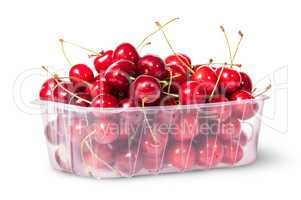 Red juicy sweet cherries in a plastic tray rotated