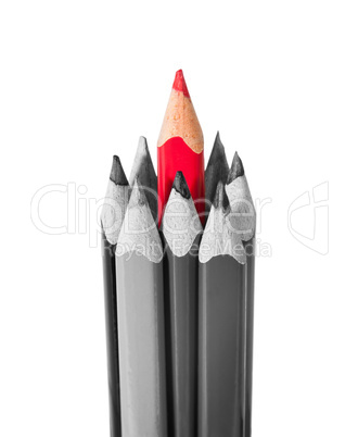 Red pencil surrounded by black and white pencils