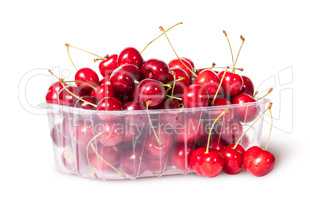 Red sweet cherries in plastic tray rotated and three near